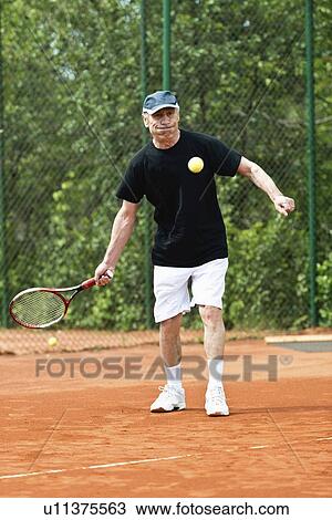 Active senior man playing tennis View Large Photo Image Stock Image - Active senior man playing tennis. Fotosearch