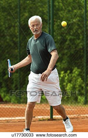 Active senior man playing tennis View Large Photo Image Stock Image - Active senior man playing tennis. Fotosearch