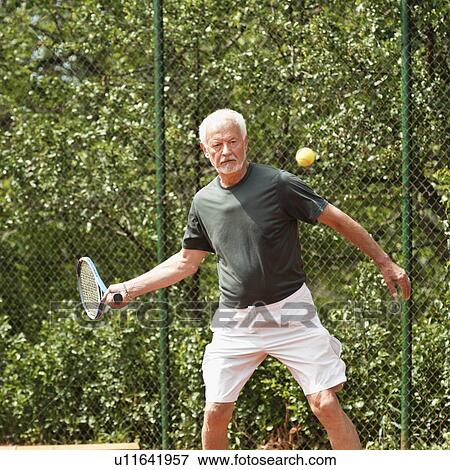 Stock Photo - Active senior man playing tennis. Fotosearch