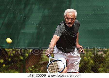 Active senior man playing tennis View Large Photo Image Stock Photo - Active senior man playing tennis. Fotosearch
