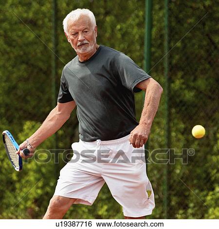 Stock Photograph - Active senior man playing tennis. Fotosearch