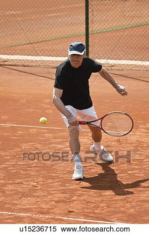 Stock Photography - Active senior man playing tennis. Fotosearch