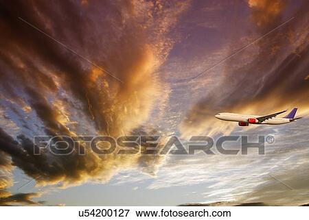 Stock Photo - Airliner against a dramatic sky. Fotosearch