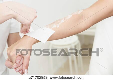 Stock Image - Arm waxing. Fotosearch