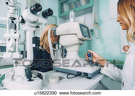 Stock Image - Auto refractometer eye examination. Fotosearch