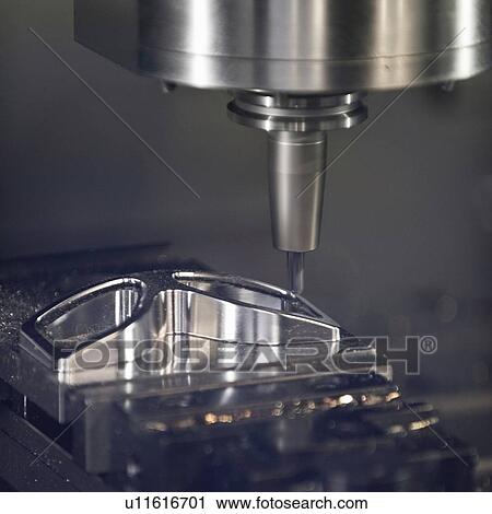 Stock Image - Automated metal work lathe. Fotosearch