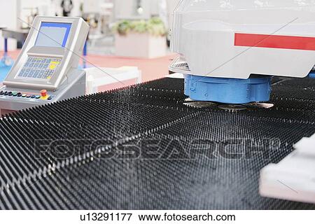 Stock Photo - Automated metalwork machine. Fotosearch