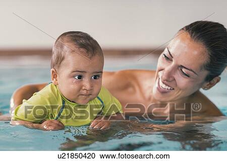 Baby boy and mother in swimming pool View Large Photo Image Stock Image - Baby boy and mother in swimming pool. Fotosearch