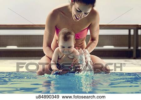 Baby boy and mother in swimming pool View Large Photo Image Stock Photo - Baby boy and mother in swimming pool. Fotosearch