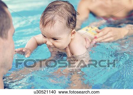 Stock Image - Baby boy swimming. Fotosearch