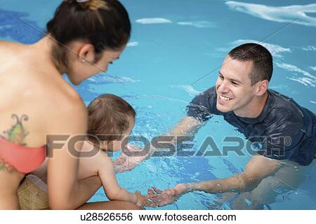Stock Photograph - Baby entering swimming pool. Fotosearch