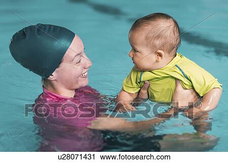 Baby swimming lesson View Large Photo Image Stock Image - Baby swimming lesson. Fotosearch