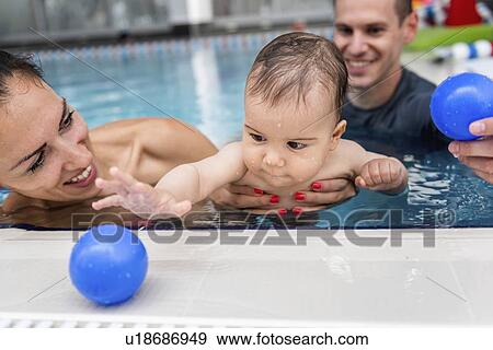 Stock Photo - Baby swimming lesson. Fotosearch