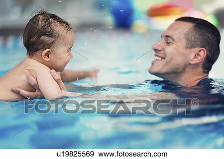 Stock Photo - Baby swimming lesson. Fotosearch