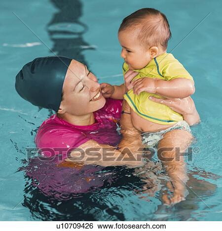 Stock Photograph - Baby swimming lesson. Fotosearch