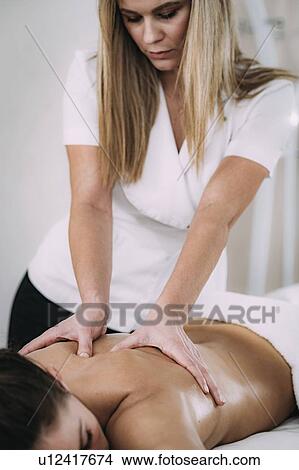 Back massage View Large Photo Image Picture - Back massage. Fotosearch