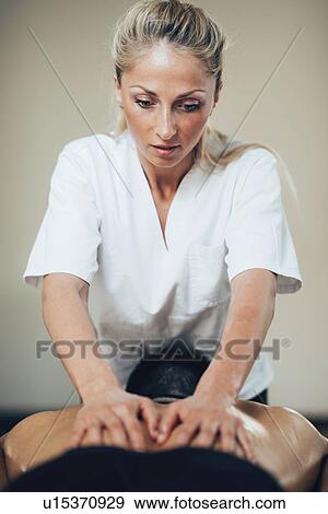 Back massage View Large Photo Image Stock Photo - Back massage. Fotosearch