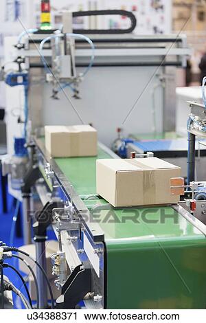 Stock Image - Box on a conveyor belt. Fotosearch
