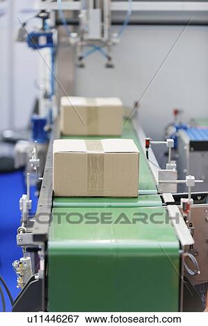 Stock Photo - Boxes on a conveyor belt. Fotosearch