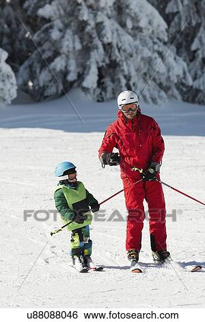 Stock Photograph - Boy having skiing lesson. Fotosearch