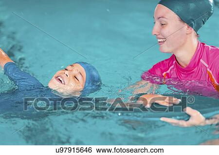 Stock Photograph - Boy in swimming class. Fotosearch