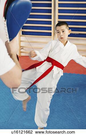Boy kicking punching bag View Large Photo Image Stock Image - Boy kicking punching bag. Fotosearch
