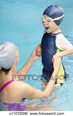 Stock Photograph - Boy learning to swim. Fotosearch
