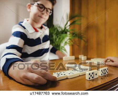 Boy playing dominoes View Large Photo Image Stock Image - Boy playing dominoes. Fotosearch