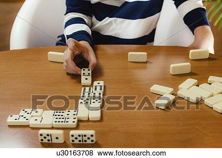 Boy playing dominoes View Large Photo Image Stock Photo - Boy playing dominoes. Fotosearch