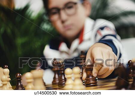 Stock Image - Boys playing chess. Fotosearch
