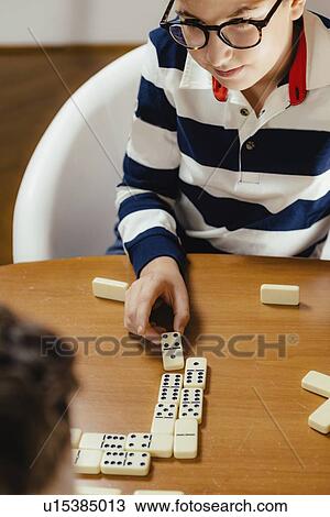 Boys playing dominoes View Large Photo Image Stock Image - Boys playing dominoes. Fotosearch