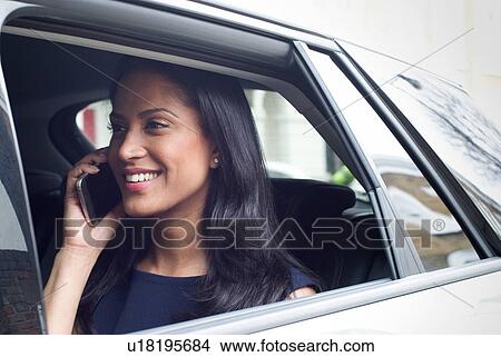 Picture - Business woman sitting in car. Fotosearch