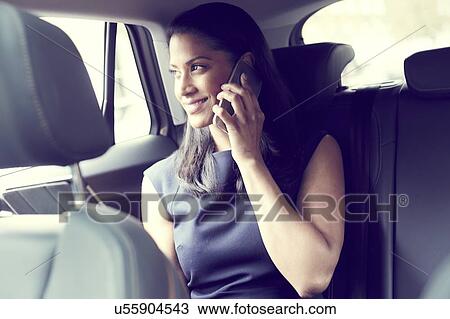 Stock Image - Business woman sitting in car. Fotosearch