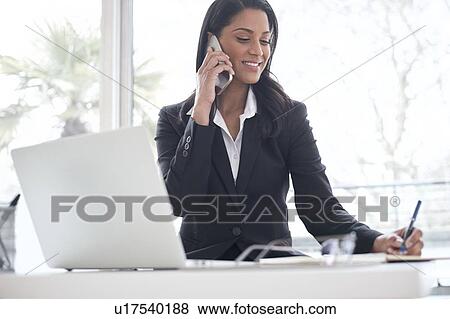 Business woman using smartphone View Large Photo Image Stock Photo - Business woman using smartphone. Fotosearch