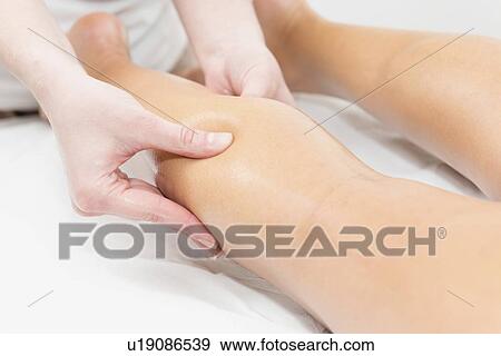 Stock Photo - Calf massage. Fotosearch