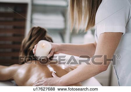 Candle wax massage View Large Photo Image Stock Photo - Candle wax massage. Fotosearch