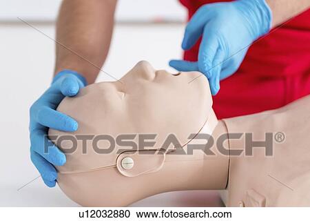 Stock Image - Cardiopulmonary resuscitation training. Fotosearch