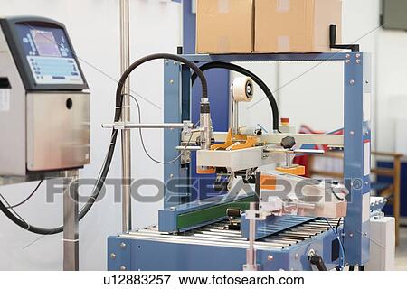 Stock Photo - Carton sealing machine. Fotosearch