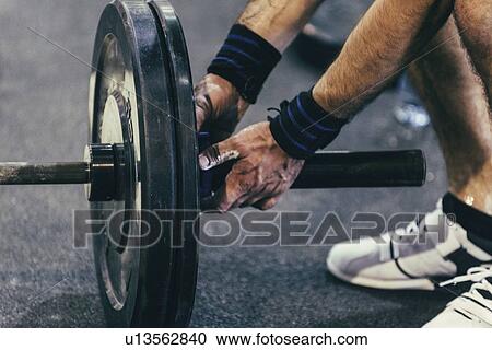 Changing weights on barbell View Large Photo Image Stock Image - Changing weights on barbell. Fotosearch