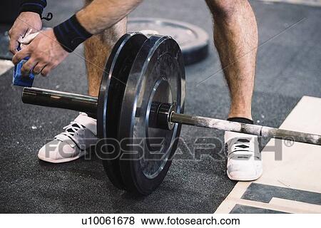 Changing weights on barbell View Large Photo Image Stock Photo - Changing weights on barbell. Fotosearch