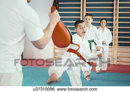 Children in taekwondo class View Large Photo Image Stock Photograph - Children in taekwondo class. Fotosearch