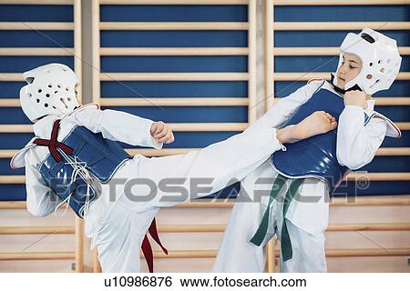 Children sparring in taekwondo class View Large Photo Image Stock Photograph - Children sparring in taekwondo class. Fotosearch