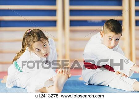 Children stretching in taekwondo class View Large Photo Image Stock Photo - Children stretching in taekwondo class. Fotosearch