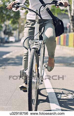 Commuter using electric bicycle View Large Photo Image Stock Photograph - Commuter using electric bicycle. Fotosearch