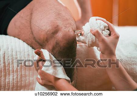 Stock Image - Cryo massage for knee pain. Fotosearch