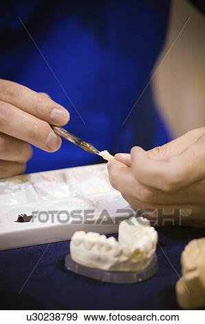 Stock Photo - Dental prosthetic technician at work. Fotosearch
