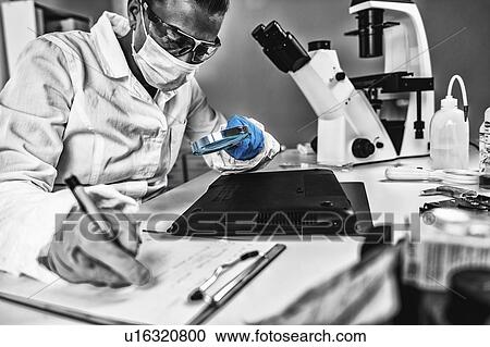 Stock Image - Digital forensic investigator at work. Fotosearch