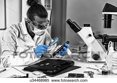 Stock Photography - Digital forensic investigator at work. Fotosearch