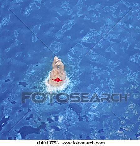 Stock Image - Diver entering water. Fotosearch