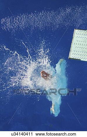 Stock Image - Diver entering water. Fotosearch